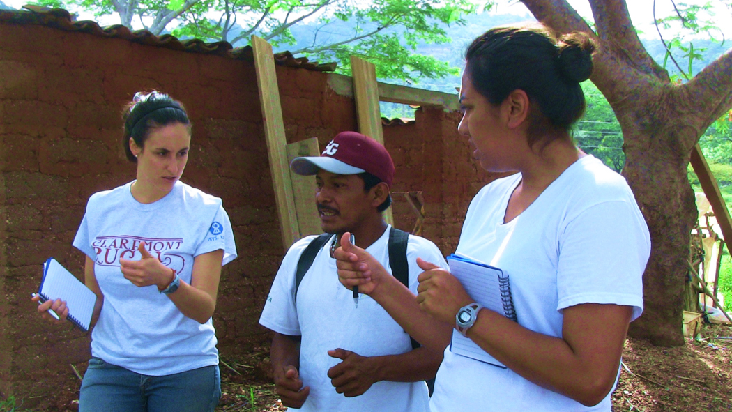 Two veterinarians speaking with a farmer.