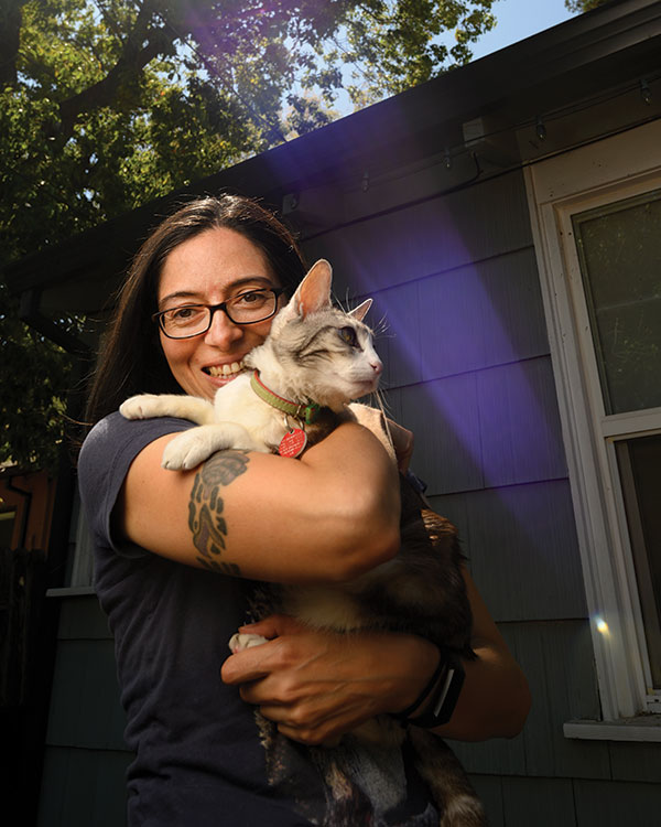 Postdoctoral researcher Mikel Delgado and her cat, Clarabelle