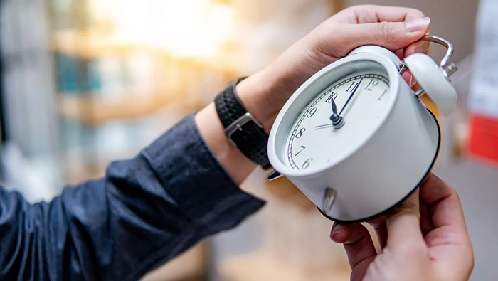 Hands change an analog clock