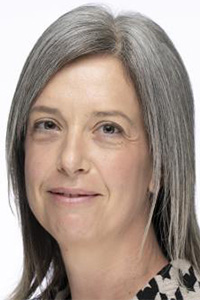 Color headshot of a woman with gray hair and soft smile, white background