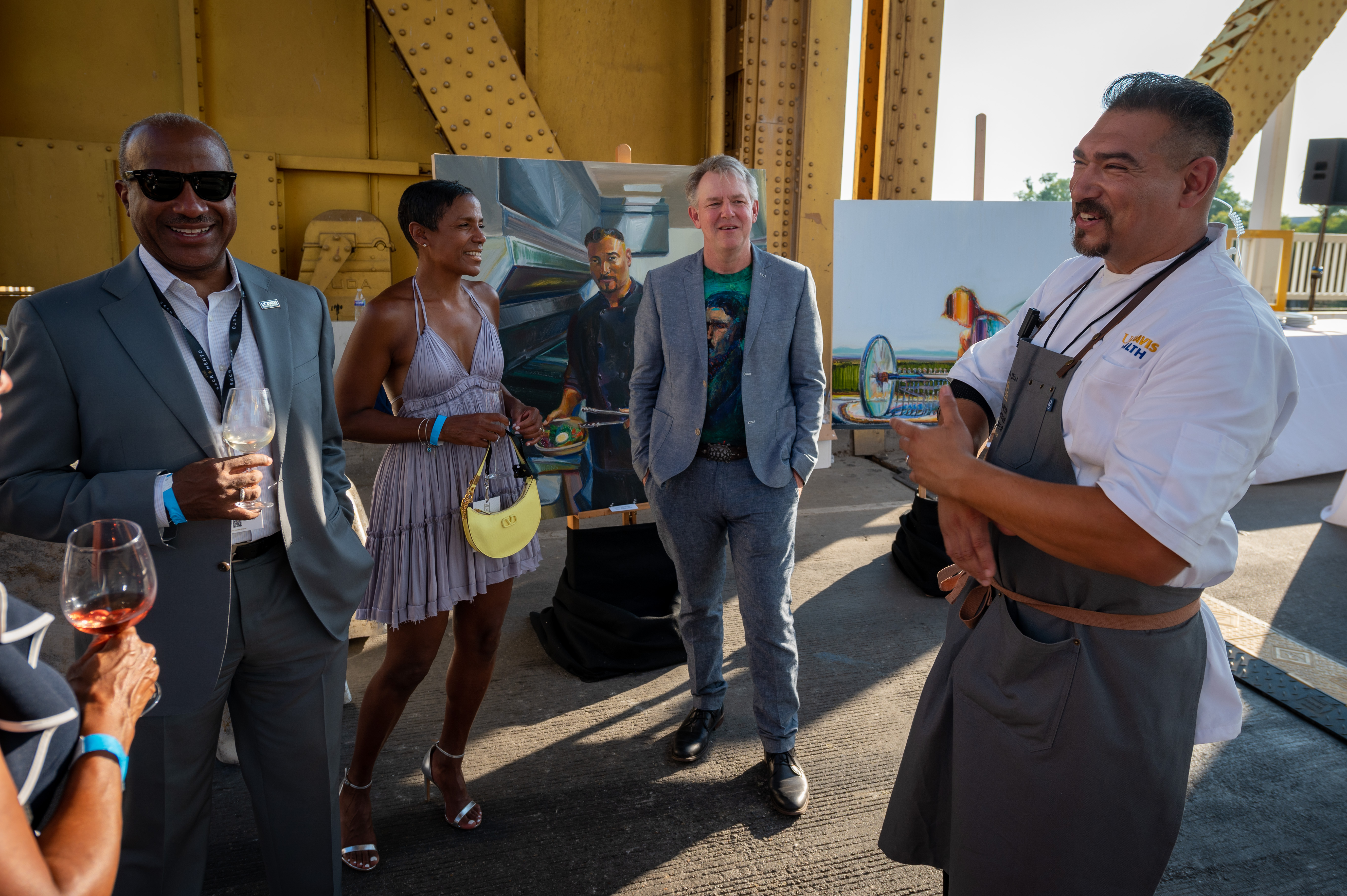 Chef Santana Diaz mingles with Chancellor Gary May and LeShelle May