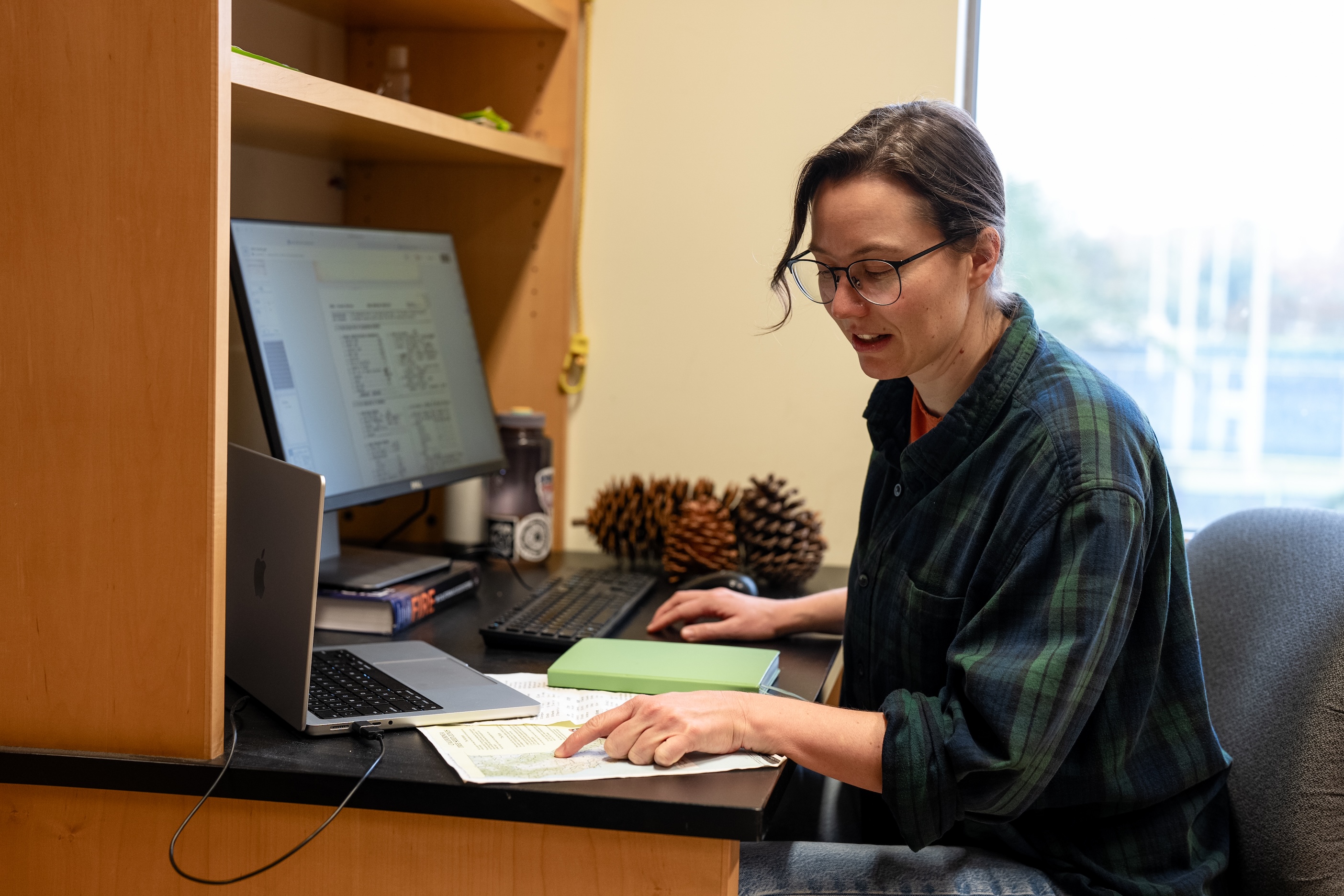 Nina Venuti sits at a desk in her lab