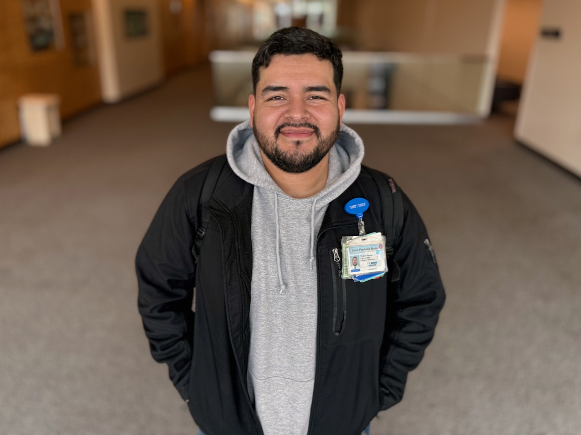 Medical student with his ID badge in a hallway