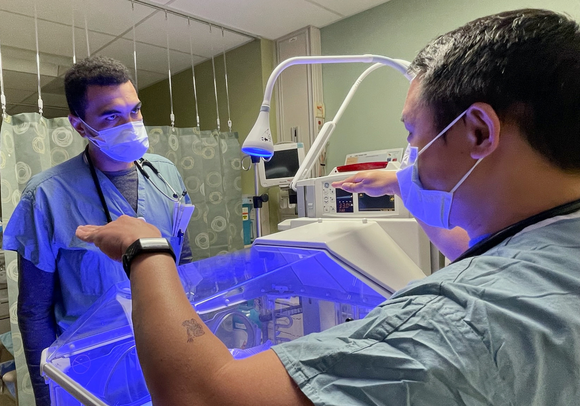 Medical student receiving training from a doctor.