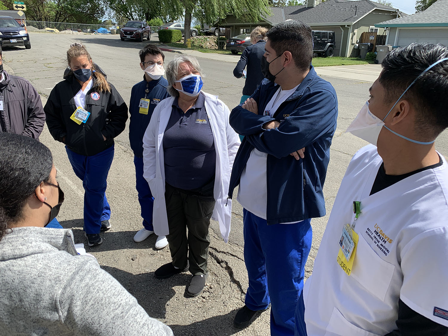 Nursing students from UC Davis Health stand in a circle outside the Knights Landing One Health Clinic.