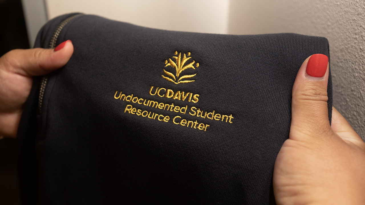 A closeup of the new graphic element for the Undocumented Student Resource Center on a sweatshirt