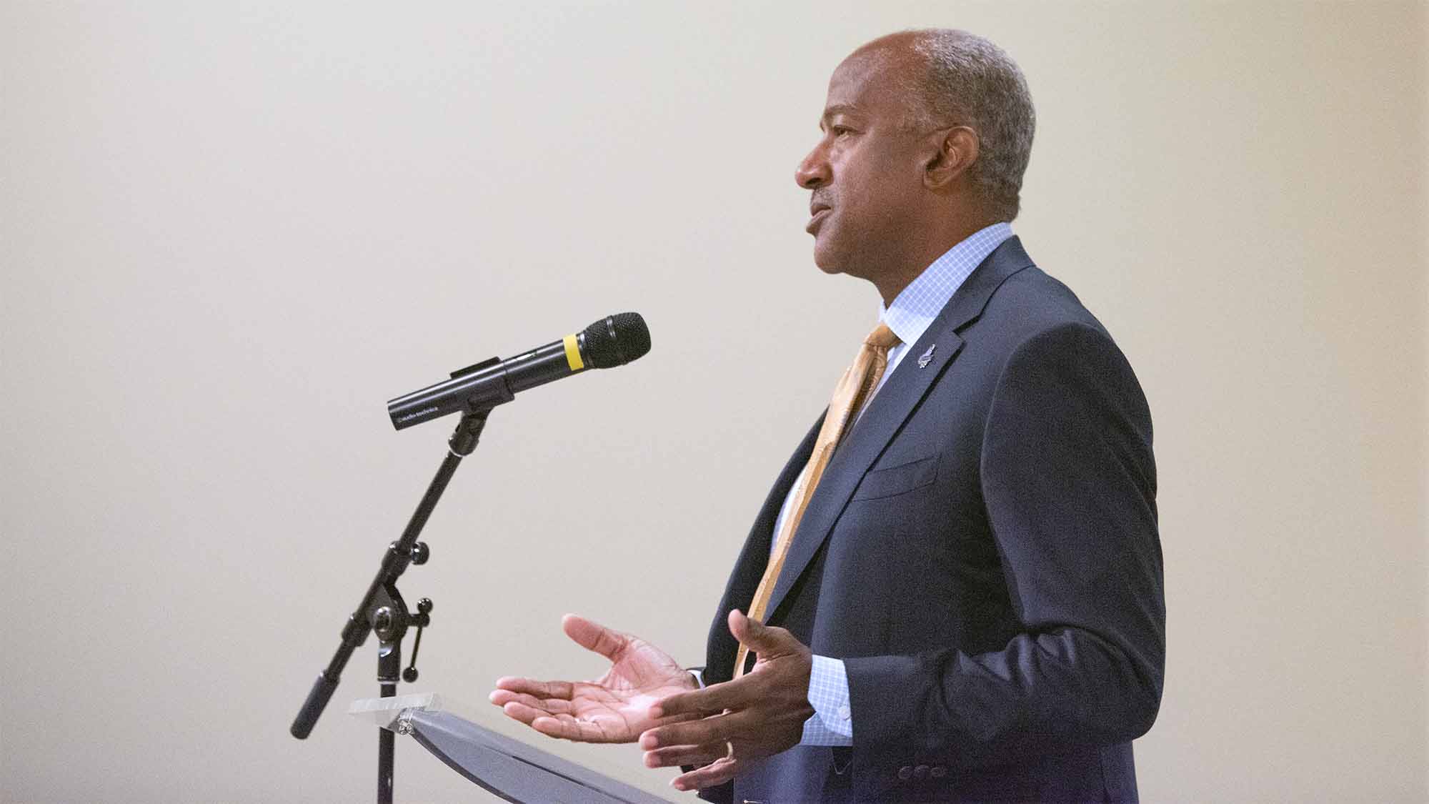 Chancellor Gary S. May speaking at lectern