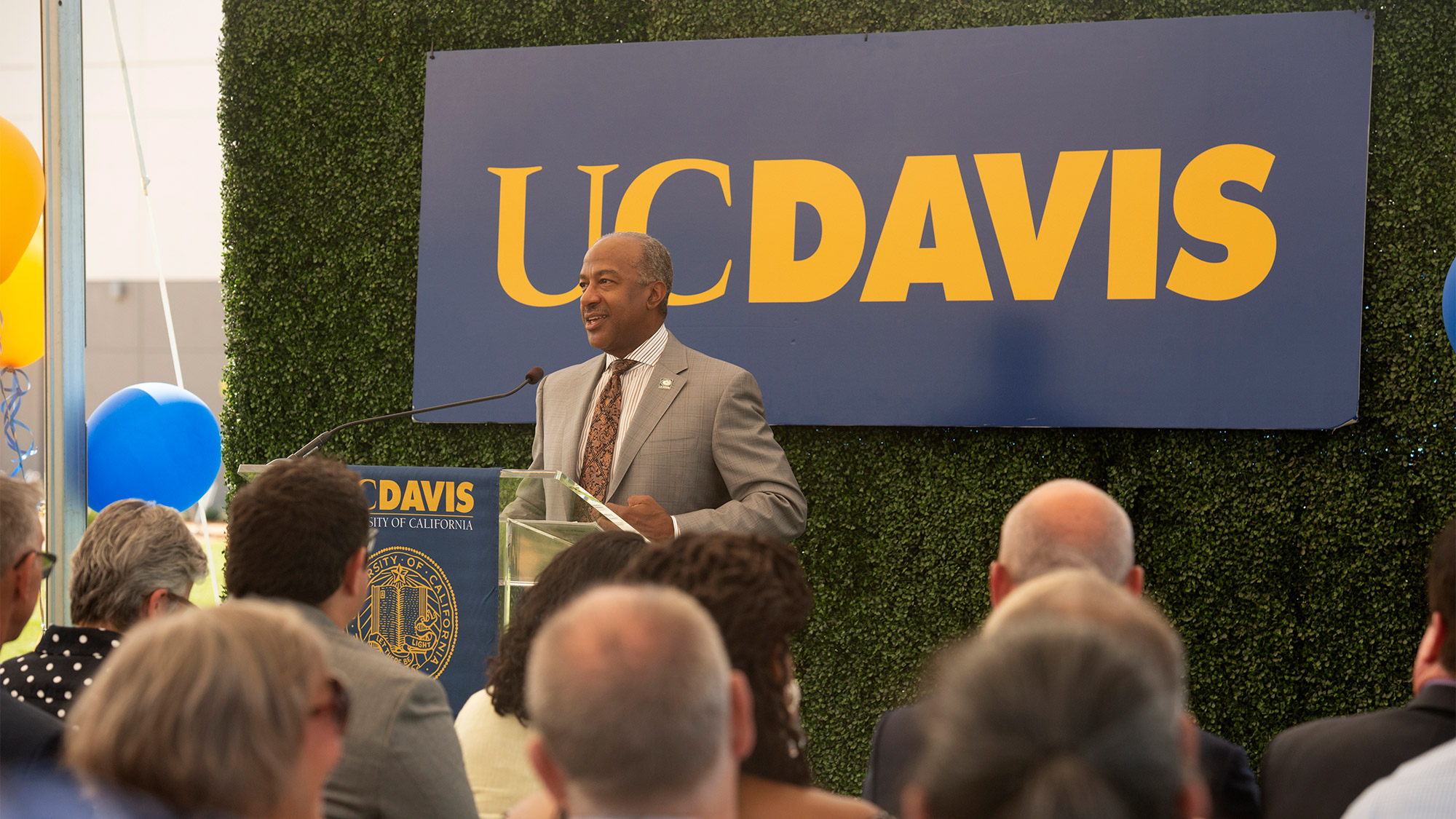 Chancellor Gary S. May speaks to a crowd at the grand opening of The Green.