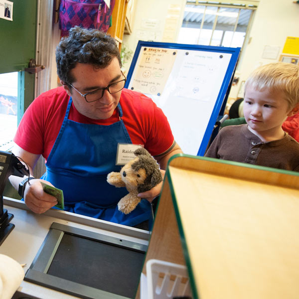 A male student 'plays house' with two children