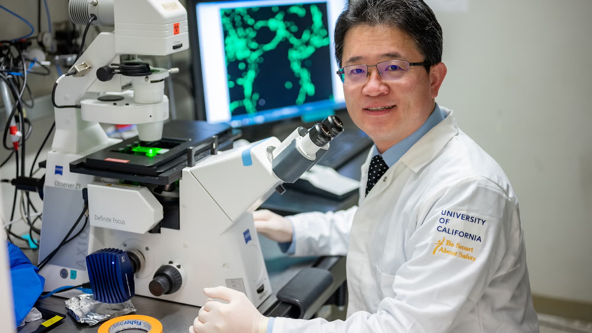 A researcher smiling in his lab