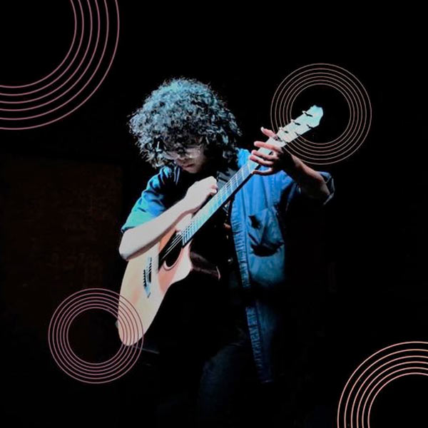 A women on stage playing guitar