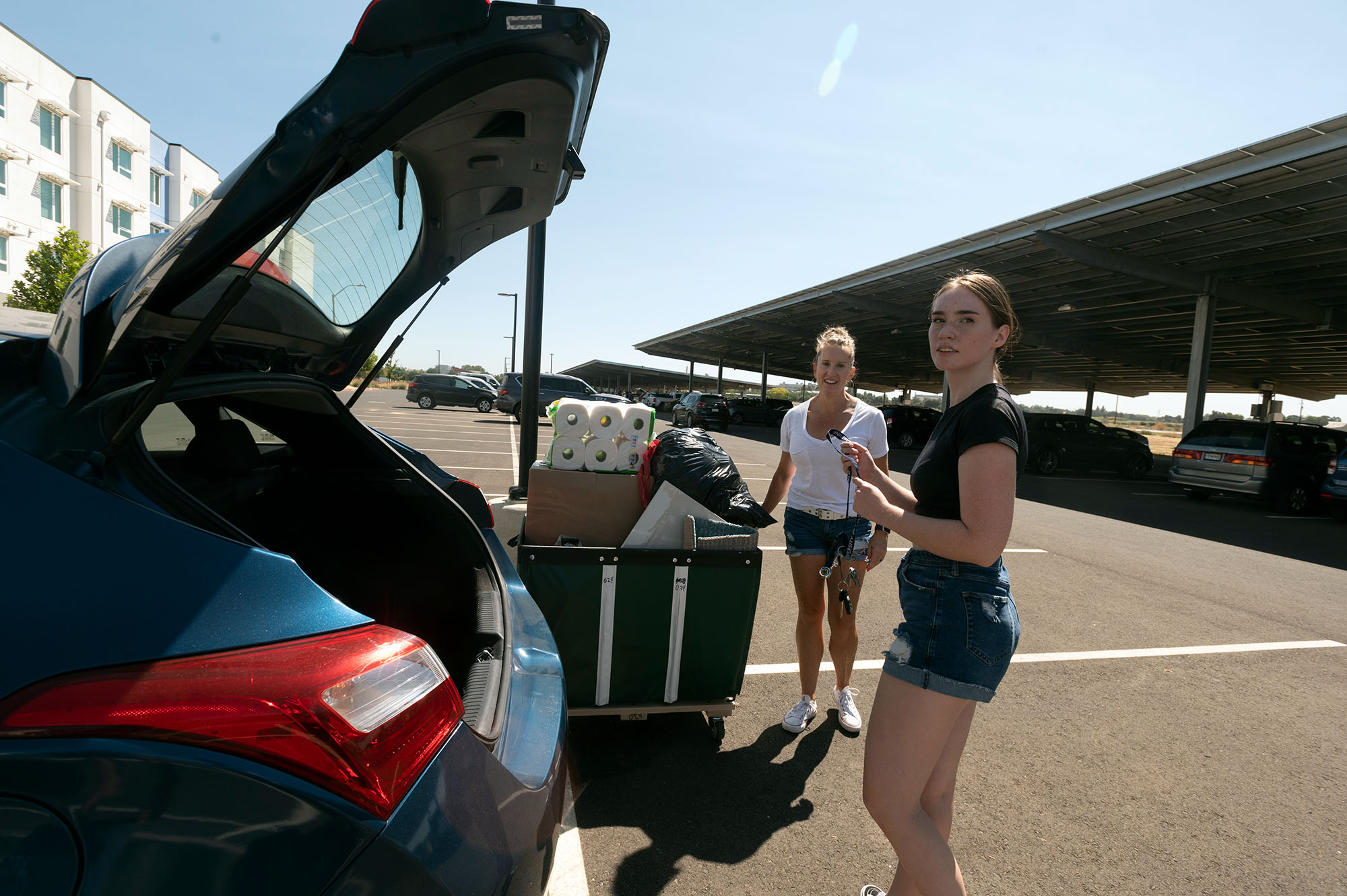 People unload a car at The Green