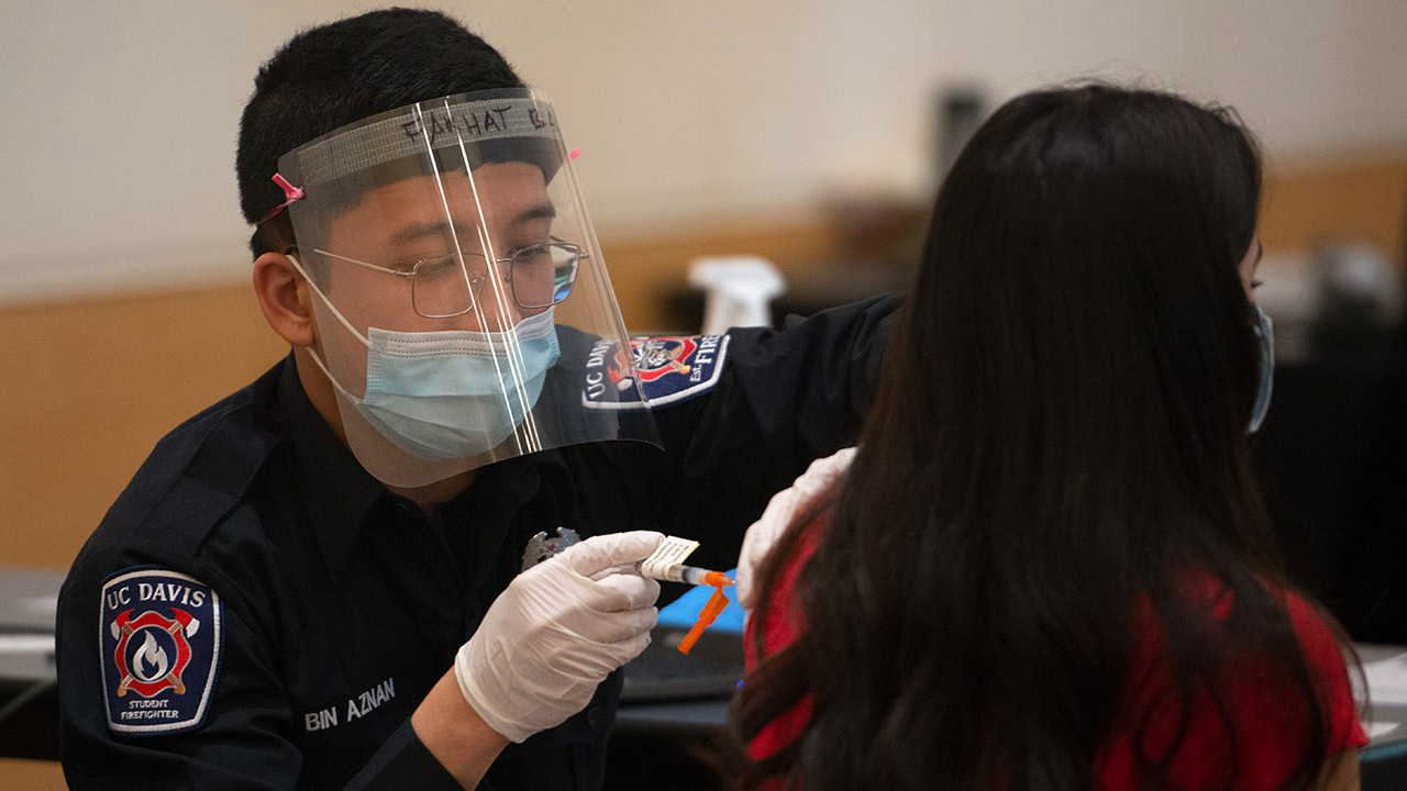 Student gives vaccine.