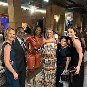 People pose for group photo at movie premiere event