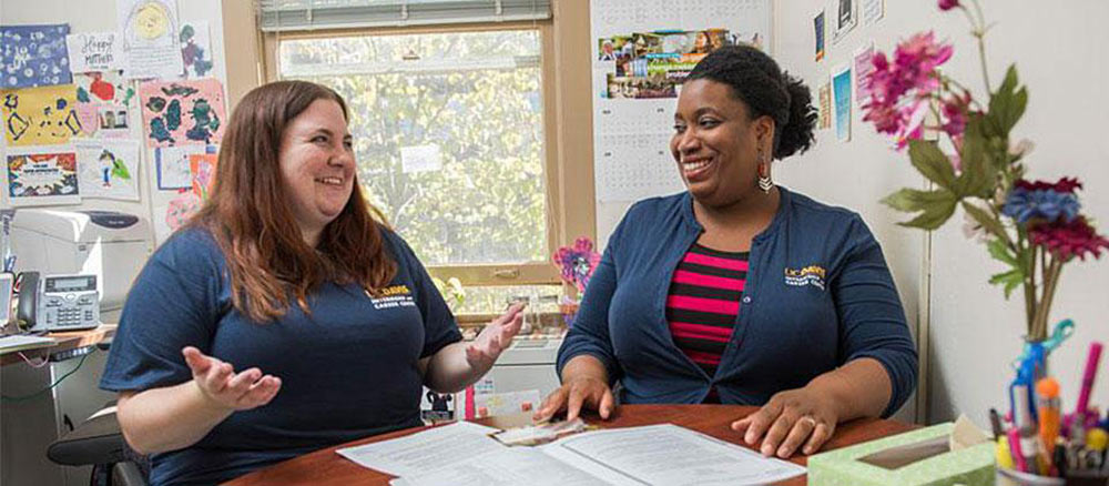 Marjannie talks with someone in her office at UC Davis. 