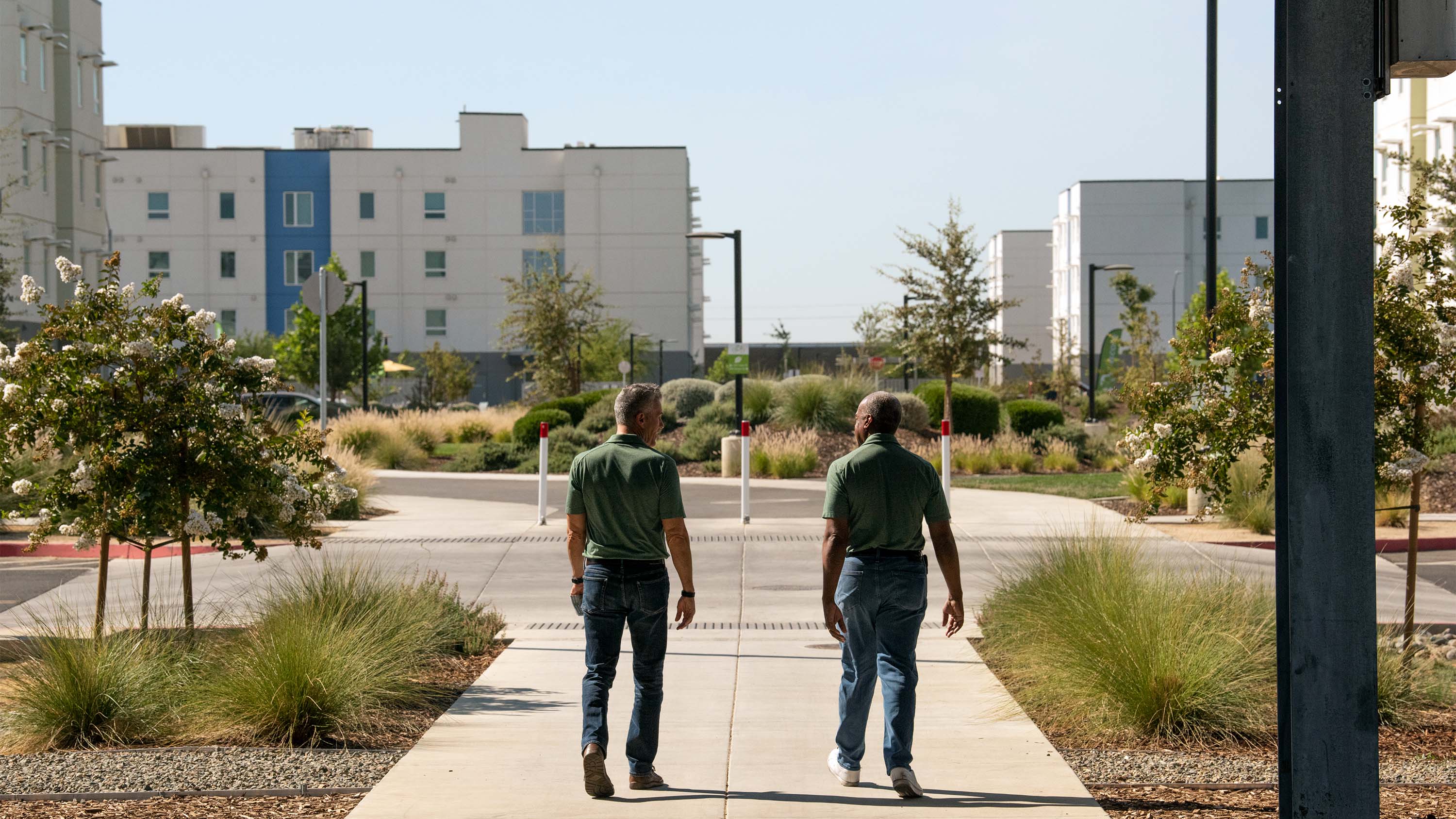 Gary S. May and Mike Sheehan walk away.