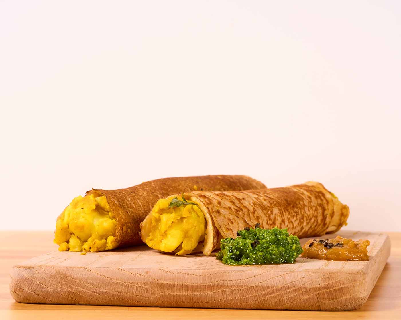 masala dosa dish on wood platter.