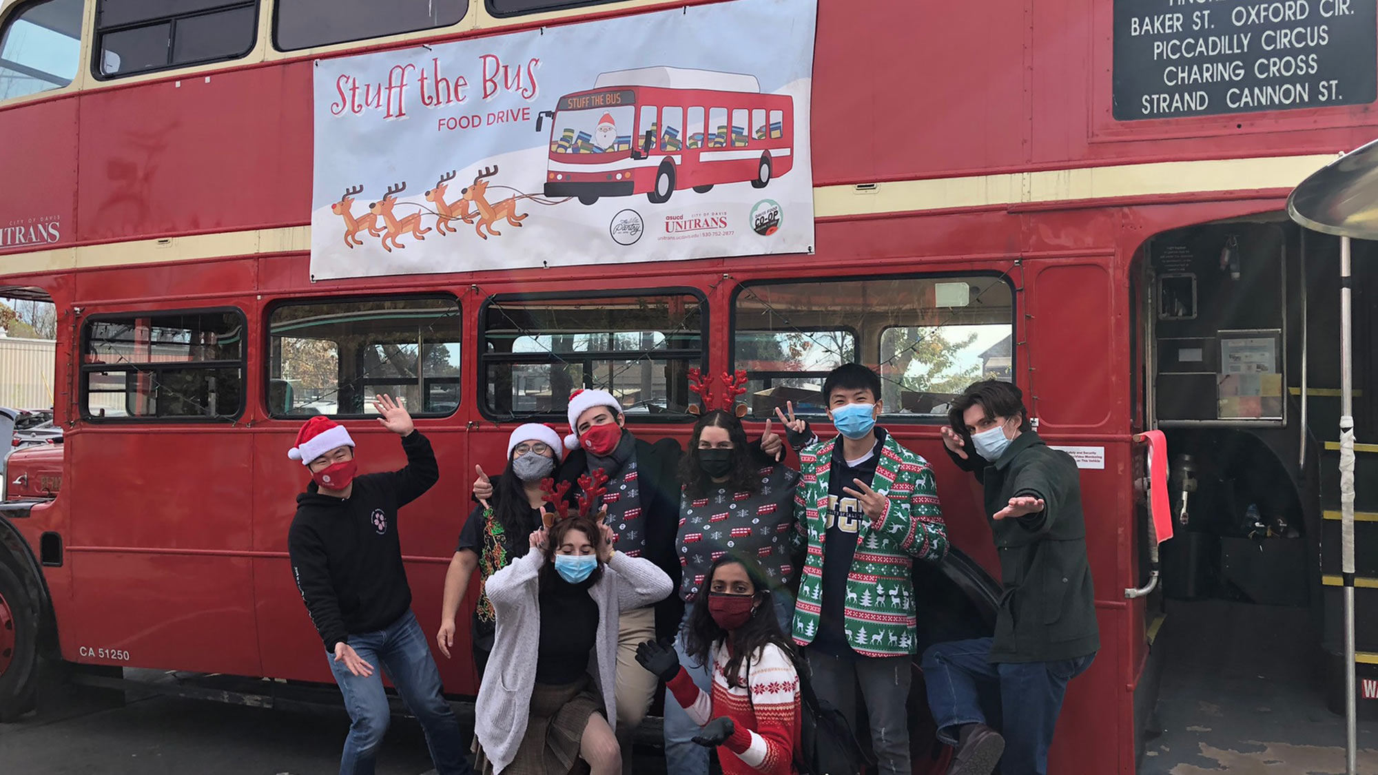 Unitrans crew in front of vintage London double-decker bus