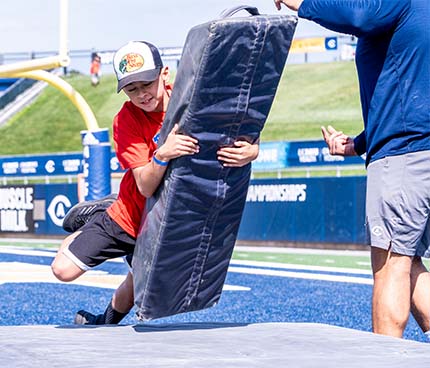 Young child does tackle drill