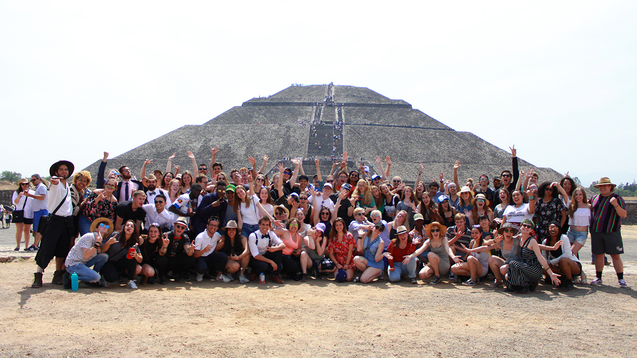 A group of students poses in front of a pyramid in Mexico City on UC Davis study abroad. 
