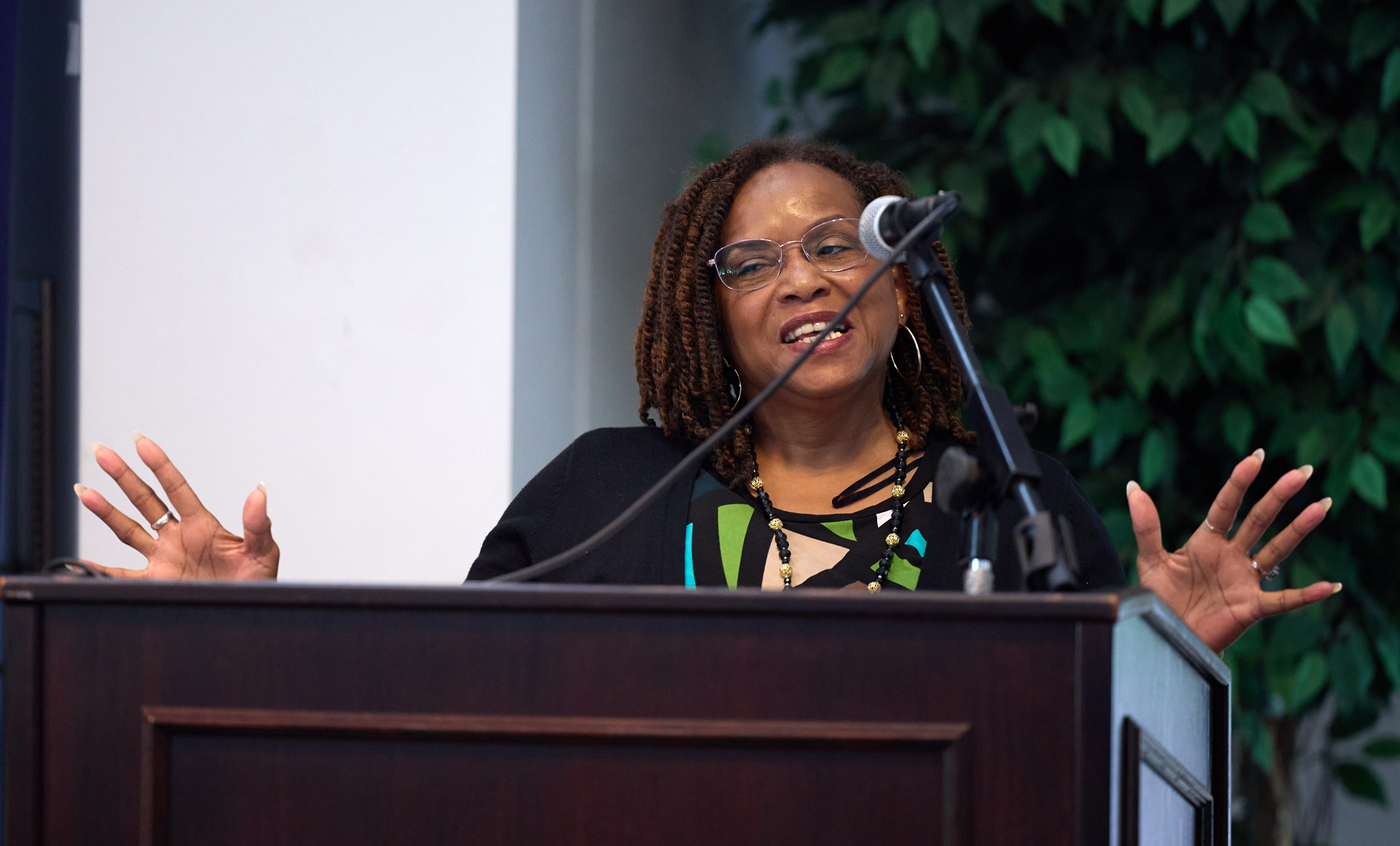 Vickie Gomez, UC Davis staff, gestures with hands at podium