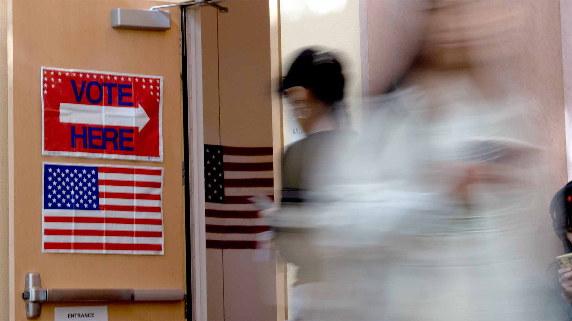 People walk past the voting center in the ARC at UC Davis