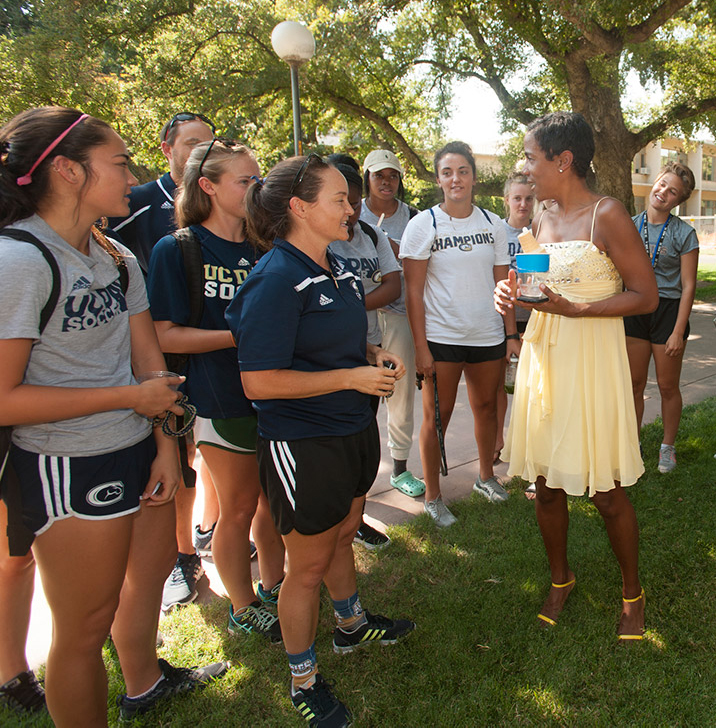 LeShelle greets women's soccer team.