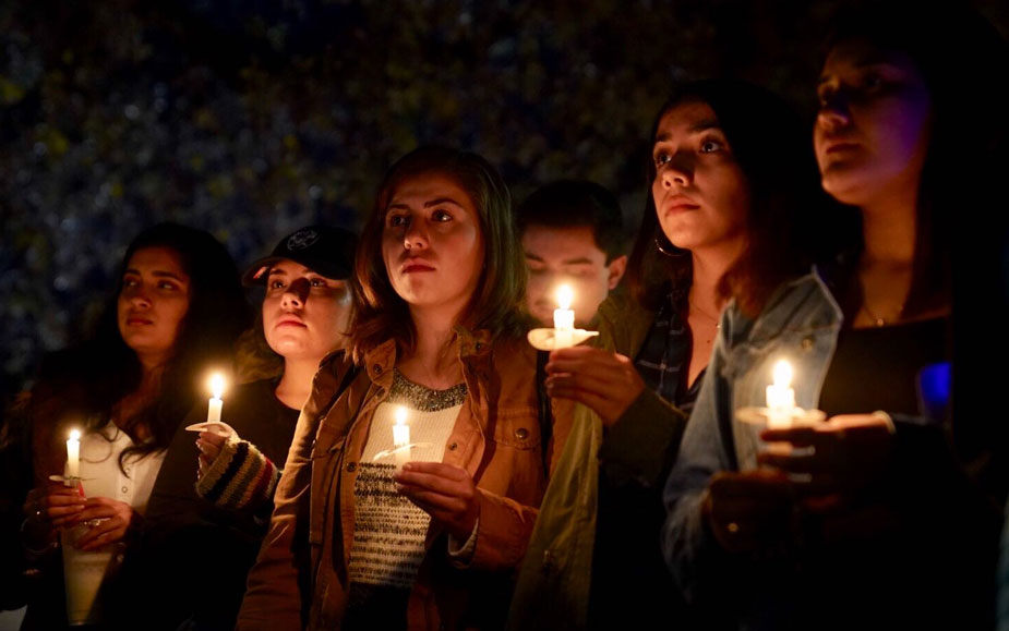 Five women hold candles.