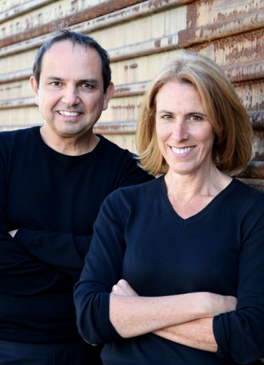 Teddy Cruz and Fonna Forman, leaning against corrugated steel wall