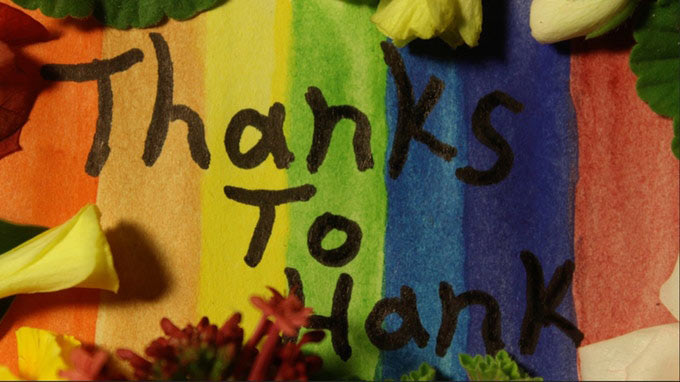 "Thanks to Hank" written over rainbow-colored background.