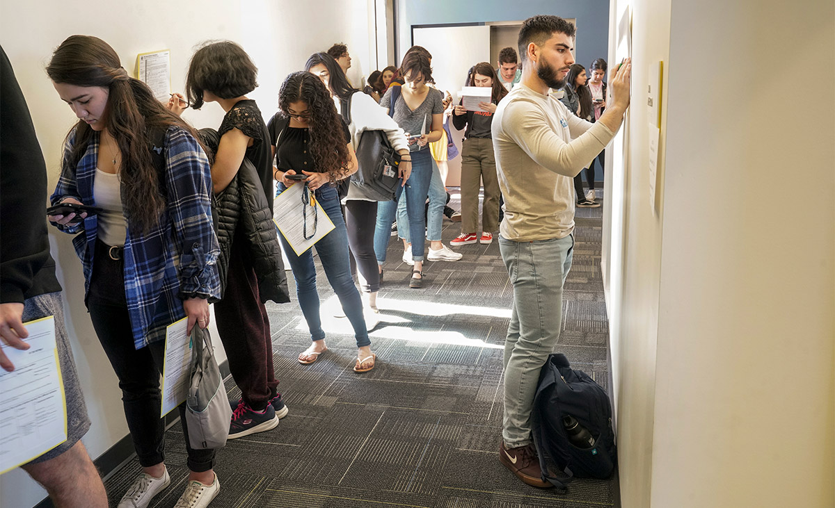 Students wait in line to vote.