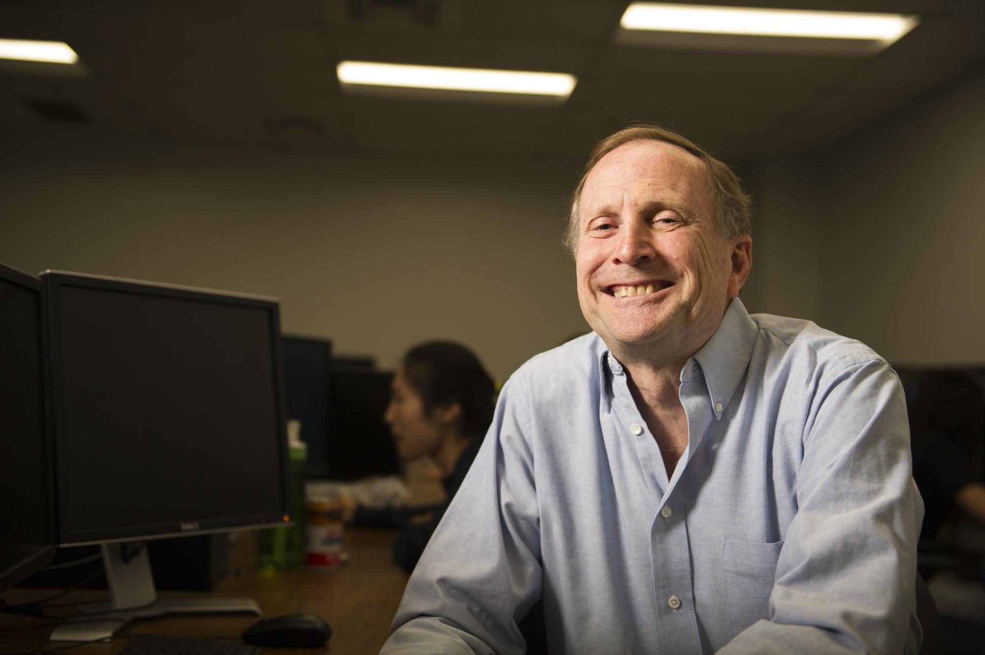 A man sits in a computer lab