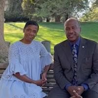 Chancellor Gary May and LeShelle sitting on a bench in Spafford Lake