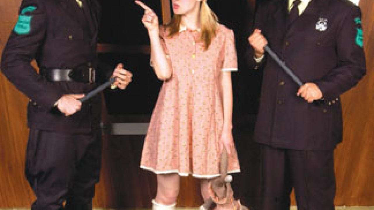 Little Sally (Allison Minick) defies Lockstock (Travis Dukelow, left) and Barrel (Yahya Rouhani) as the police officers search for rebels who have commandeered one of the &ldquo;public amenities.&rdquo; 
