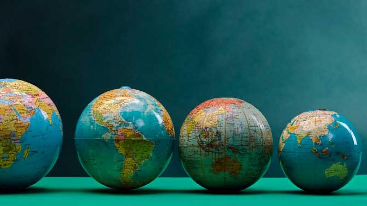 Five different-size globes in a row