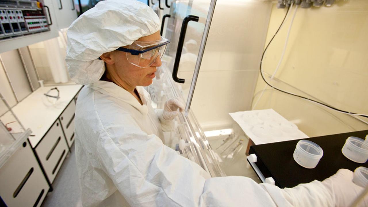 Kari Cooper in clean lab, wearing personal protective equipment