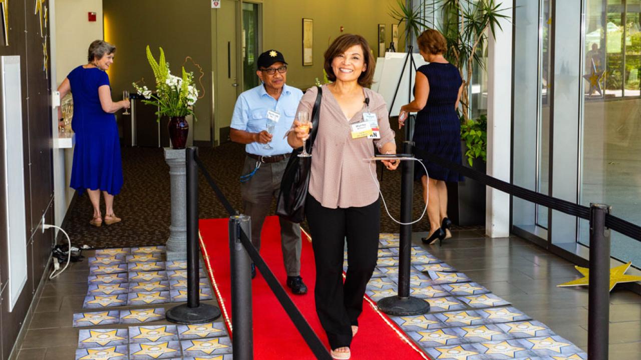 Myrna Malqued walks along red carpet.