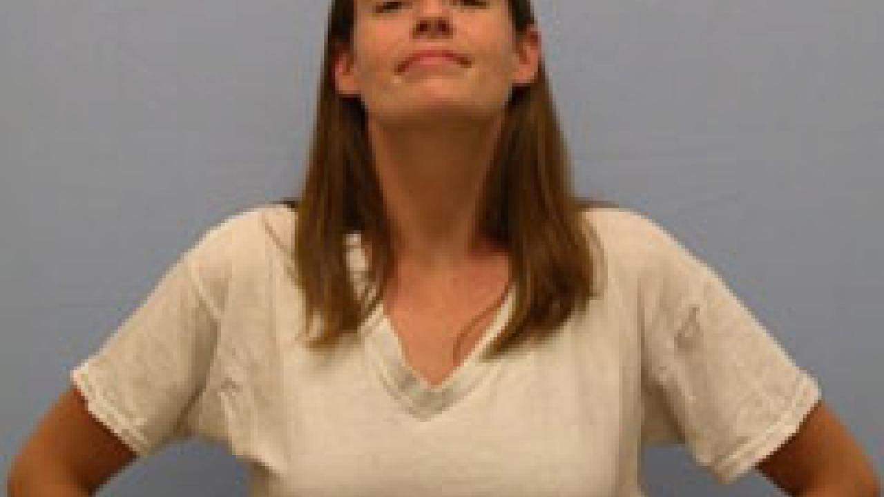 Photo: woman smiling with her hands on her hips and her chest expanded
