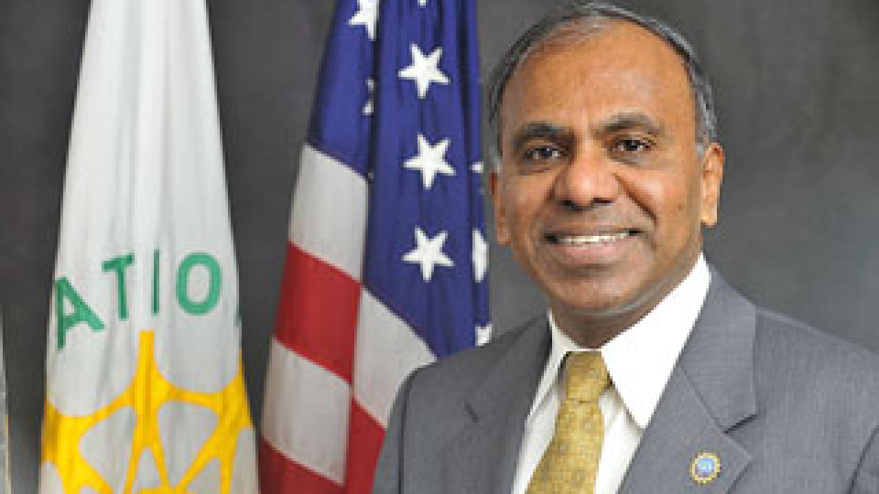 Man with flags in background