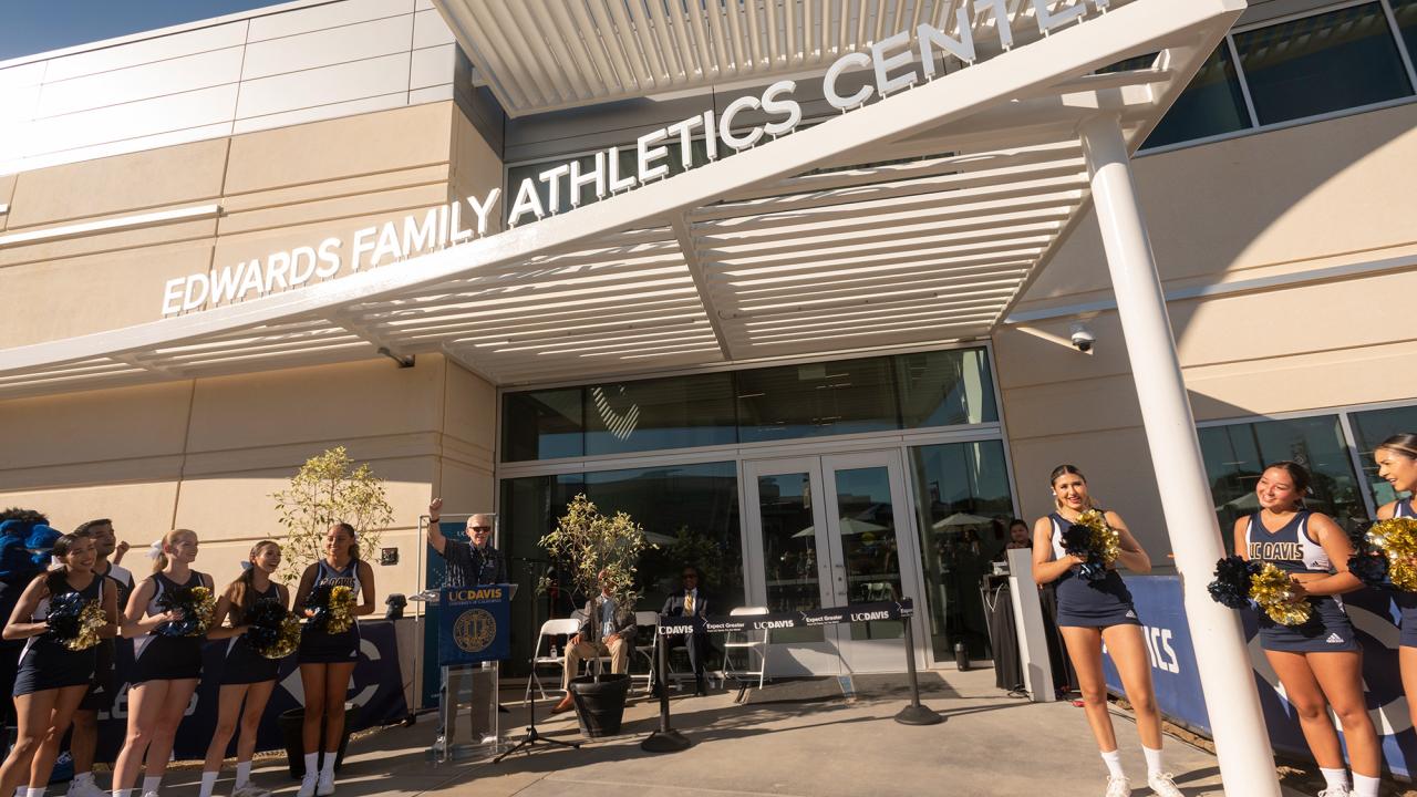 Cheerleaders outside of a building in the sun