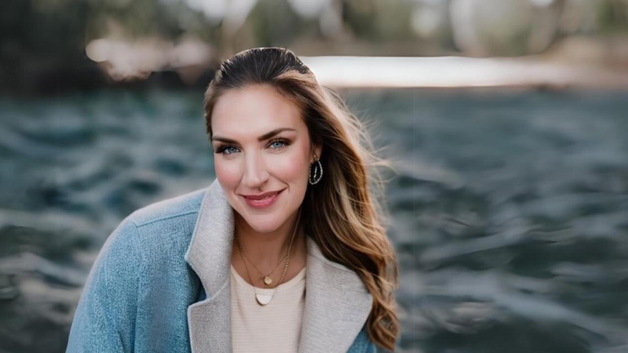 Woman sits in front of a blurry background