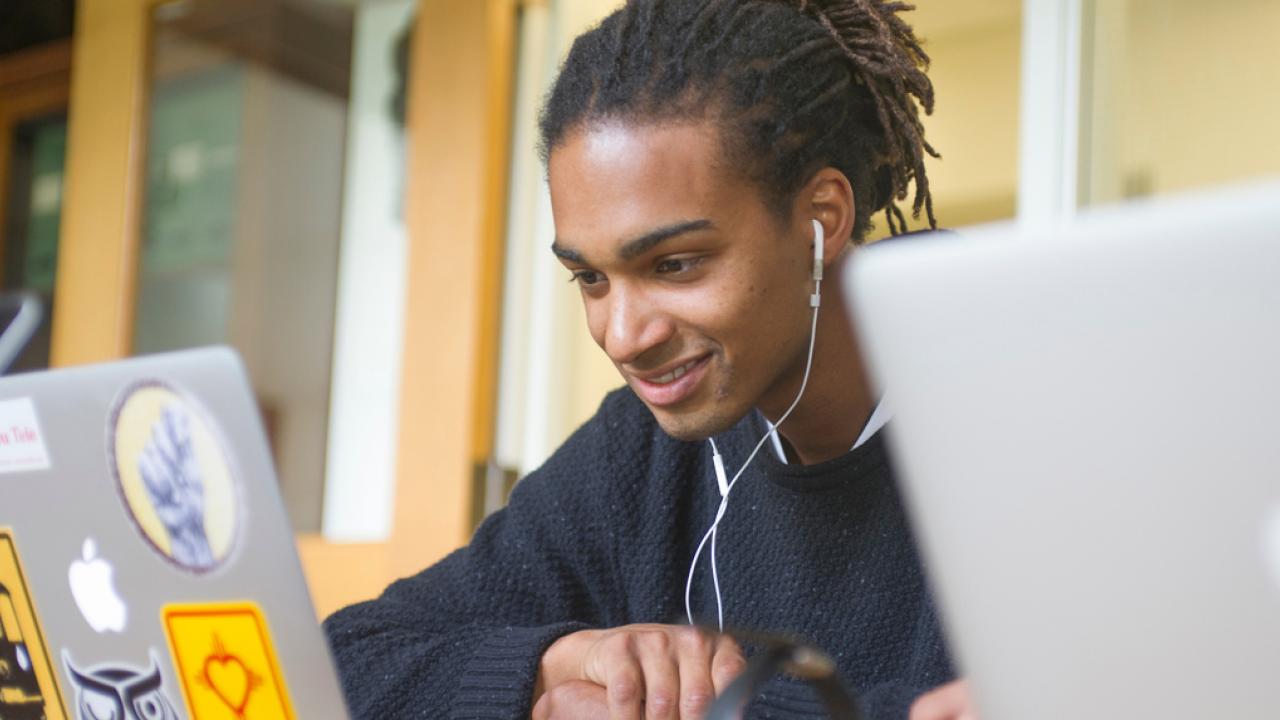 student looking at laptop computer