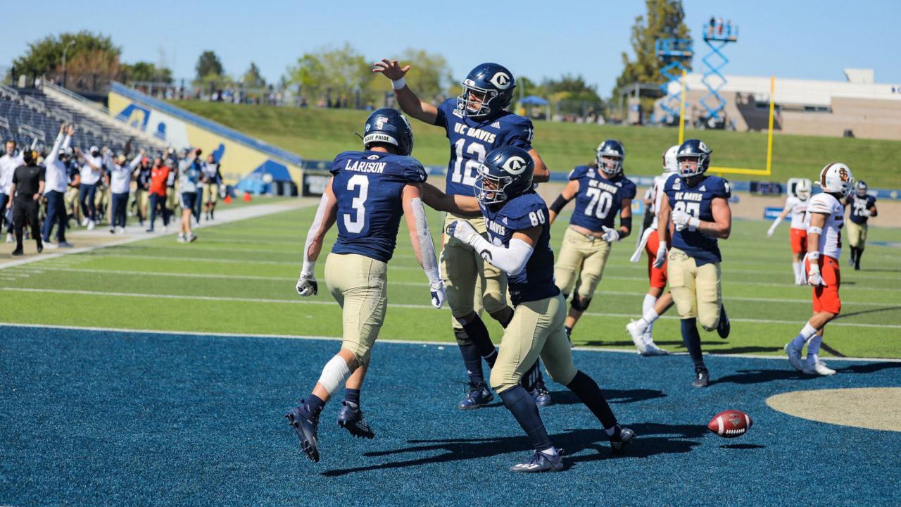 Aggie football players celebrate in endzone.