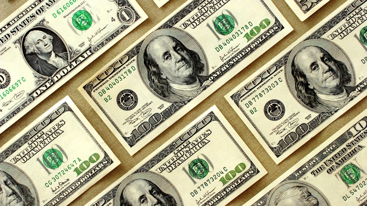 $100-dollar bills on beige background