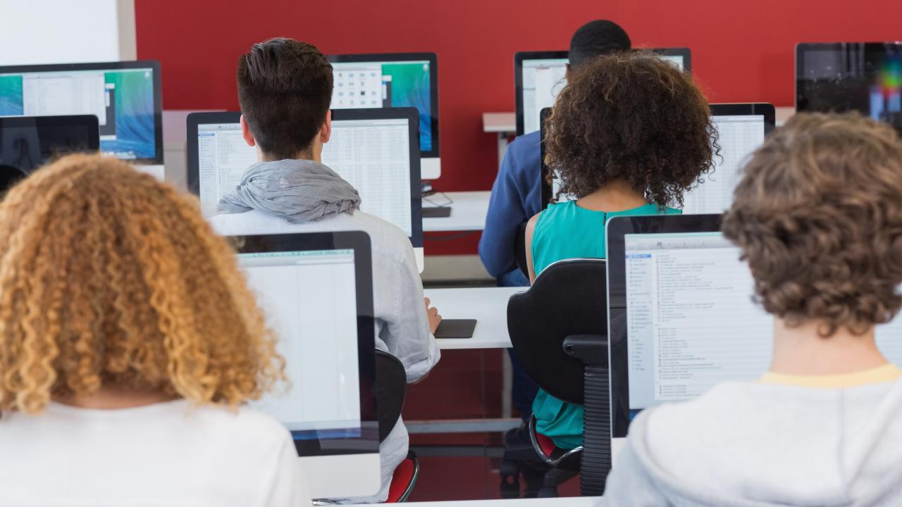 Students taking standardized tests from a screen