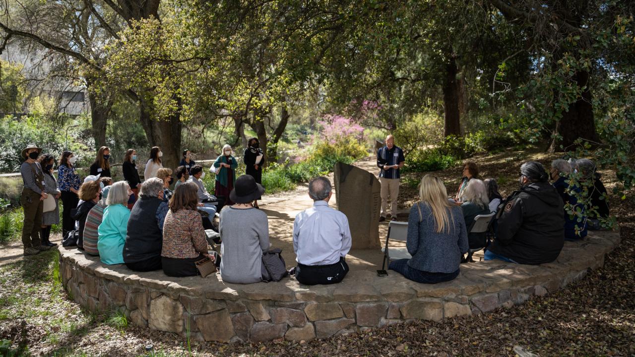 People on seating wall, in a circle
