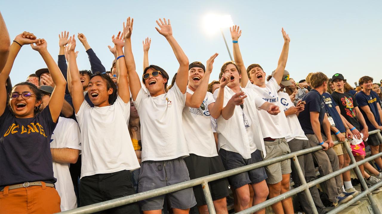 Students cheer at a football game.