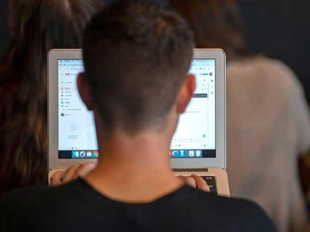 Man facing laptop