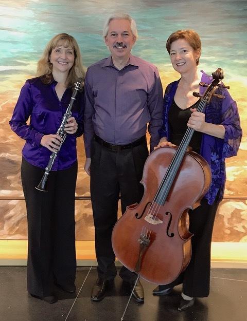 Musical trio in front of colorful background UC Davis