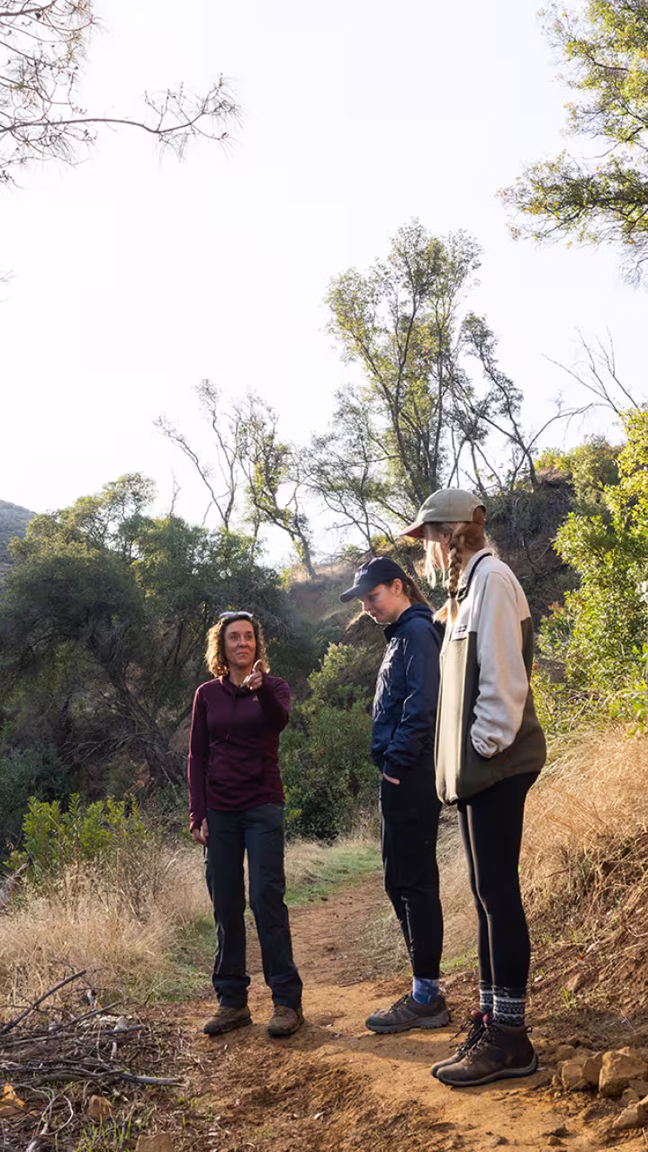 A teacher and students on a hiking trail